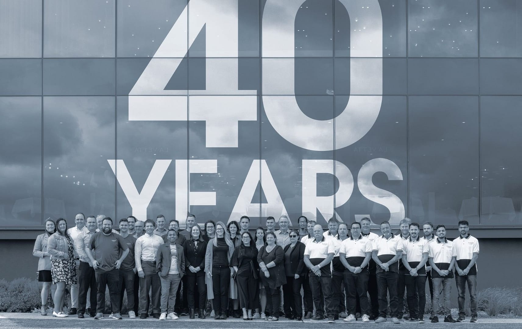 Staff photo with 40 years on window anniversary birthday dawn (1) 1 (1)